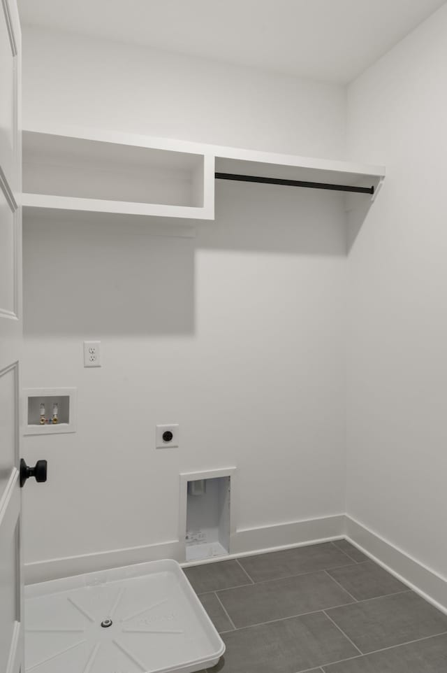 washroom featuring dark tile patterned flooring, washer hookup, and hookup for an electric dryer