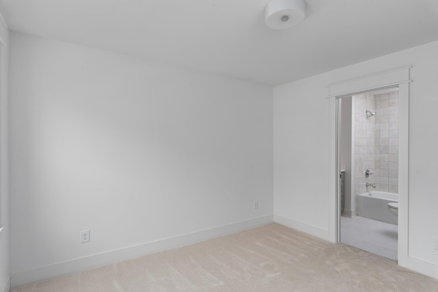 unfurnished room with light colored carpet