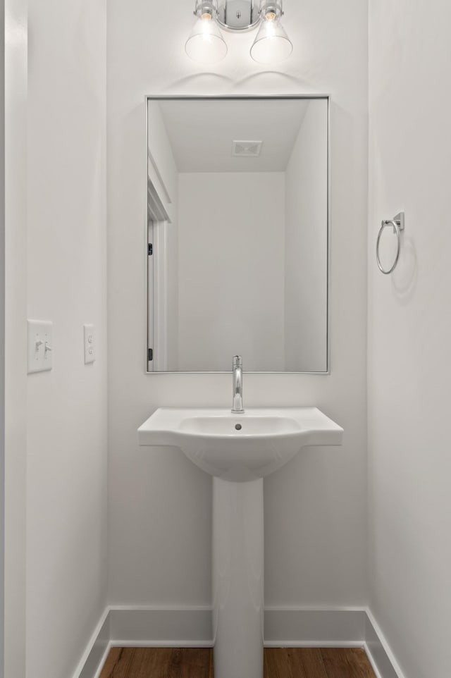 bathroom with wood-type flooring