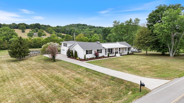 ranch-style house with a porch and a front yard