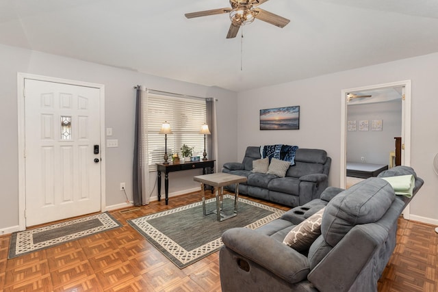 living room with ceiling fan and dark parquet floors