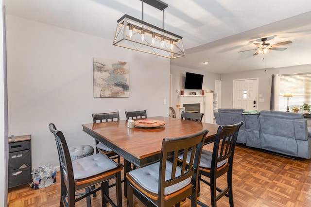 dining room with parquet flooring and ceiling fan