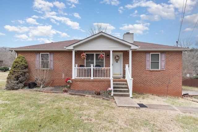 bungalow-style house featuring covered porch and a front lawn