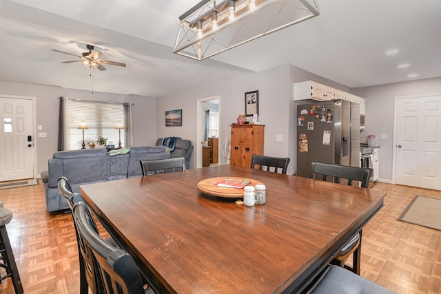 dining space featuring light parquet floors and ceiling fan