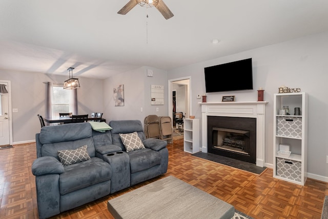 living room featuring parquet floors and ceiling fan