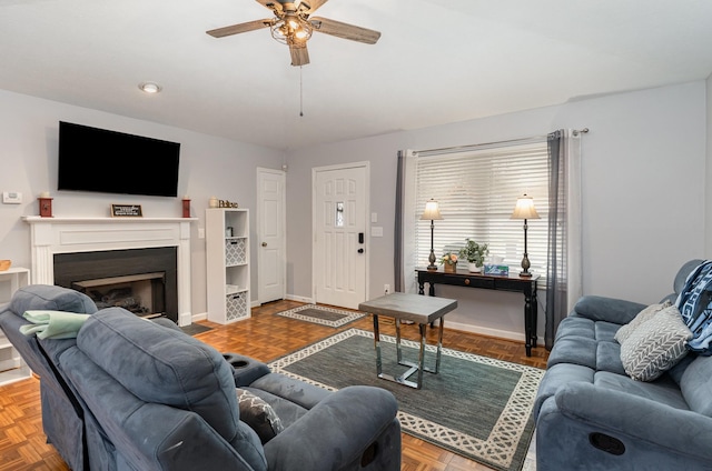 living room with ceiling fan and parquet flooring