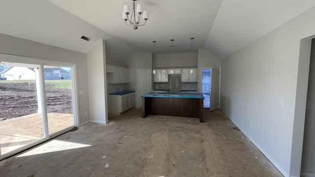 kitchen with a kitchen island, white cabinets, a chandelier, and vaulted ceiling