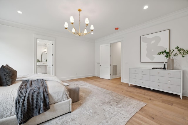 bedroom featuring ornamental molding, light wood-type flooring, an inviting chandelier, and ensuite bath