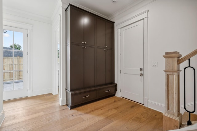 interior space with light wood-type flooring and crown molding