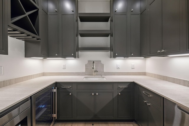 kitchen featuring sink, light stone counters, and wine cooler