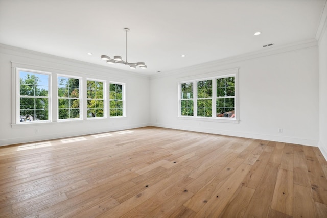 empty room with light wood-type flooring and crown molding