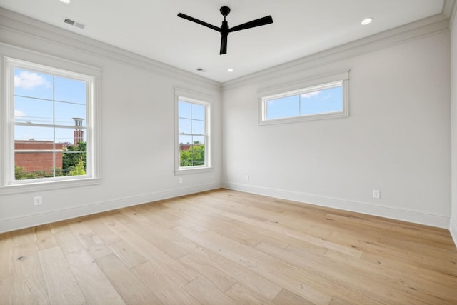 unfurnished room with ceiling fan, light wood-type flooring, crown molding, and plenty of natural light