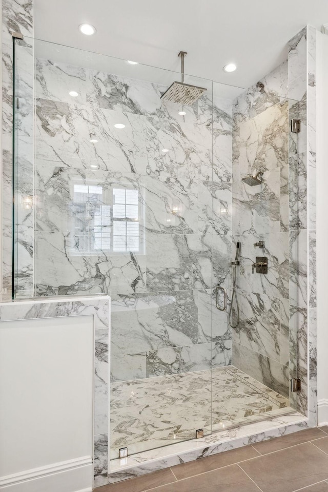 bathroom featuring a shower with shower door and tile patterned floors