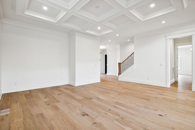 spare room with coffered ceiling, crown molding, light wood-type flooring, and beamed ceiling