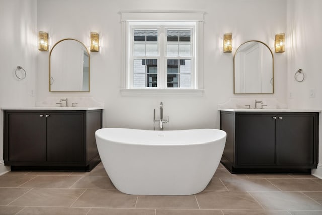 bathroom featuring tile patterned flooring, vanity, and a bathing tub