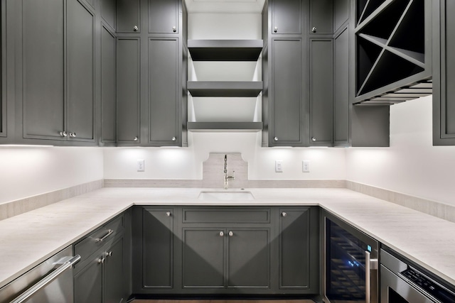 kitchen with sink, gray cabinetry, appliances with stainless steel finishes, and wine cooler