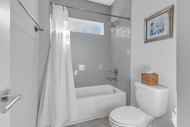 bathroom featuring toilet, tile patterned floors, and shower / bath combo