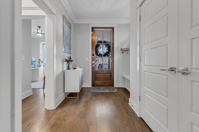 foyer featuring ceiling fan, crown molding, and wood-type flooring