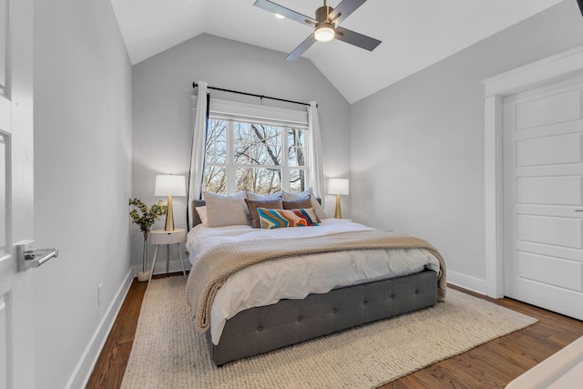 bedroom with lofted ceiling, dark hardwood / wood-style flooring, and ceiling fan