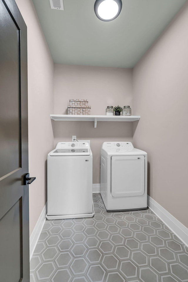 clothes washing area featuring independent washer and dryer