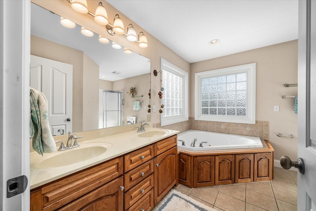 bathroom with vanity, tile patterned floors, and plus walk in shower