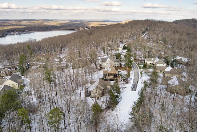 snowy aerial view featuring a water and mountain view