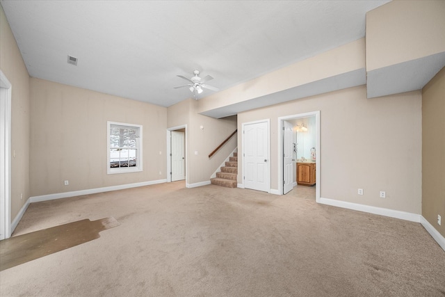 unfurnished living room featuring light carpet and ceiling fan