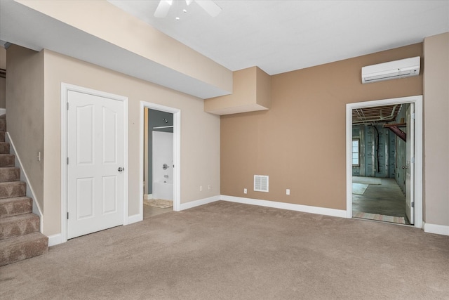 interior space with ceiling fan, a wall mounted air conditioner, and carpet flooring