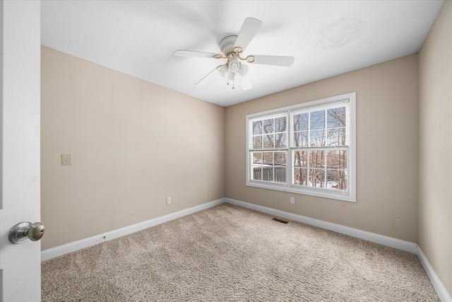 carpeted empty room featuring ceiling fan