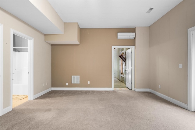 unfurnished bedroom with light colored carpet and a wall unit AC