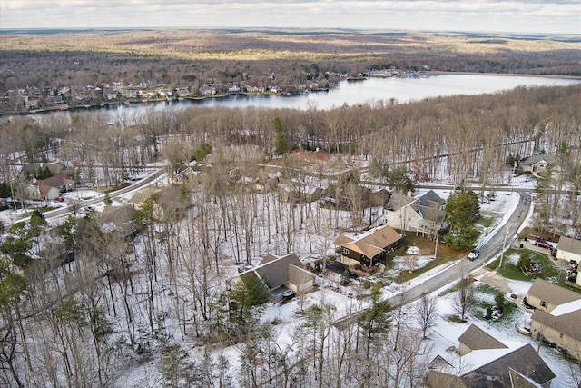 snowy aerial view with a water view