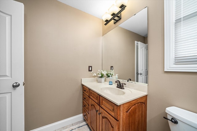 bathroom with toilet and vanity