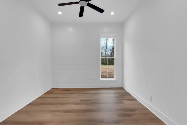 unfurnished room featuring ceiling fan and hardwood / wood-style floors