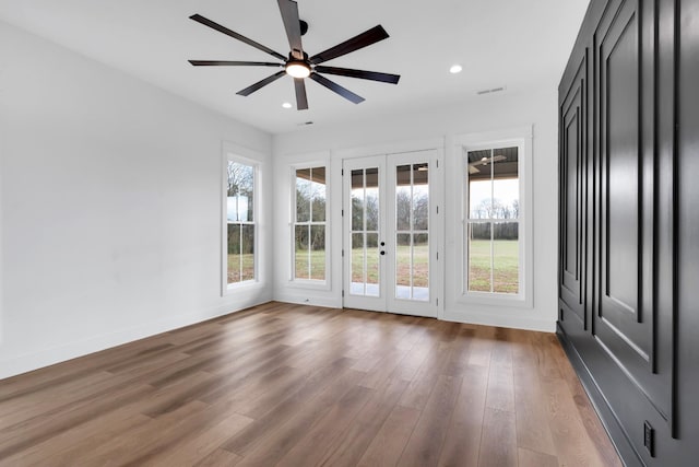 spare room with french doors, wood-type flooring, and ceiling fan