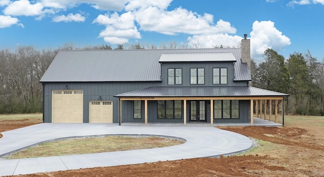 view of front of home with french doors, a garage, and a porch