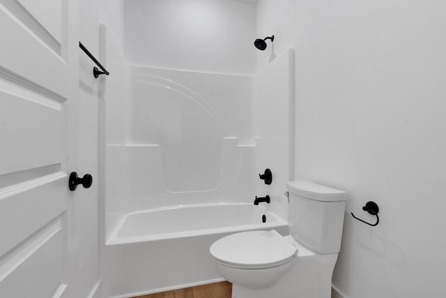 bathroom with toilet, shower / bathing tub combination, and wood-type flooring