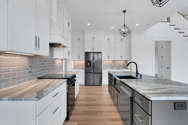 kitchen featuring dishwasher, white cabinetry, refrigerator with ice dispenser, and black range with electric cooktop