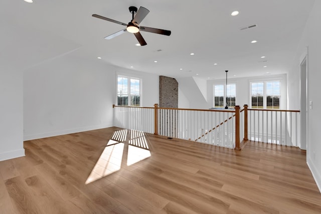 spare room with light hardwood / wood-style floors and ceiling fan