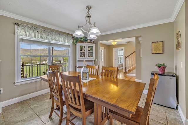 dining area with a notable chandelier, light tile patterned flooring, and crown molding