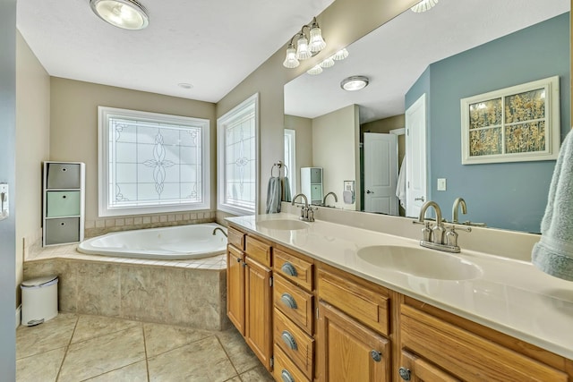 bathroom featuring tiled tub, tile patterned floors, and vanity