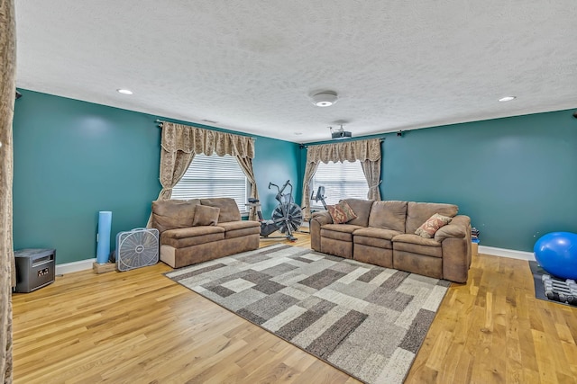 living room with a textured ceiling and light hardwood / wood-style floors