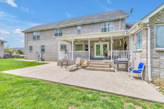 rear view of property with a porch, a patio area, ceiling fan, and a lawn