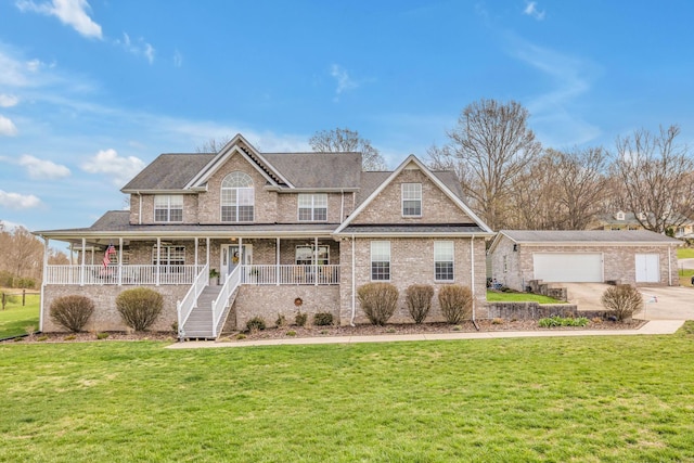 view of front of home featuring a front yard, a garage, and a porch