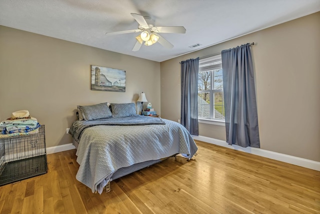 bedroom with wood-type flooring and ceiling fan