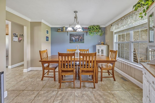 tiled dining space featuring a notable chandelier and crown molding