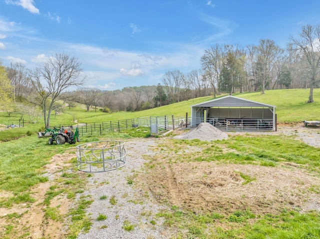 view of yard featuring a rural view and an outdoor structure