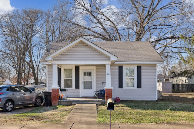 bungalow-style house featuring a porch and a front yard