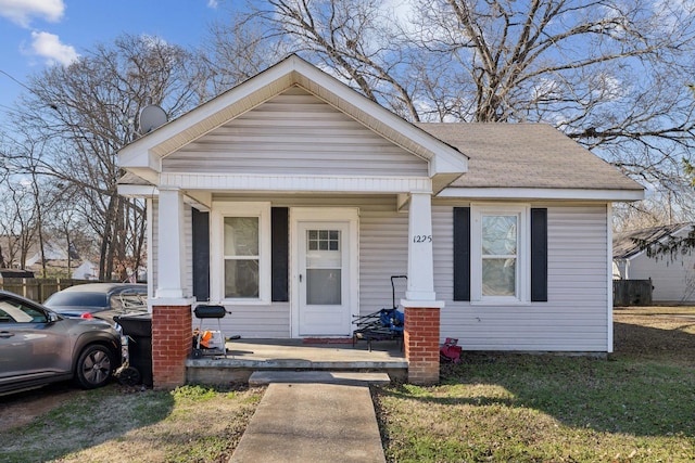 bungalow-style home with a porch and a front yard