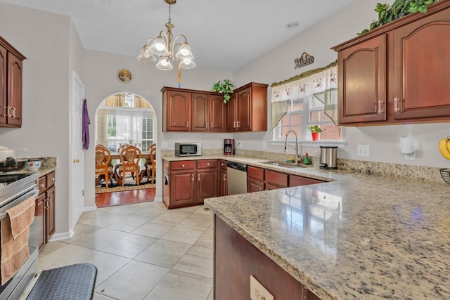 kitchen with light stone countertops, pendant lighting, a chandelier, appliances with stainless steel finishes, and sink