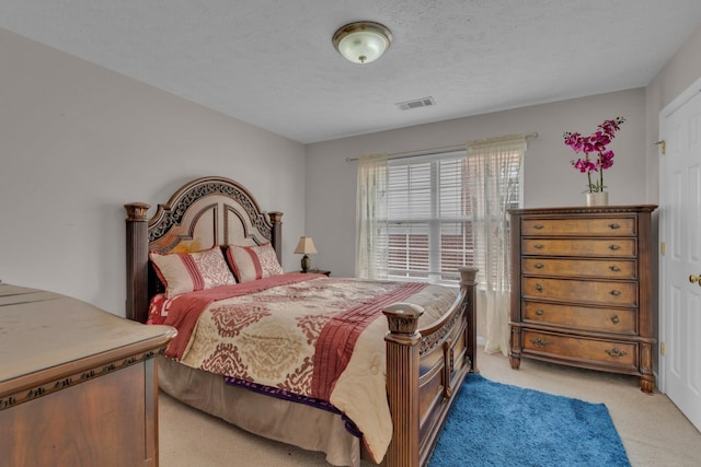 carpeted bedroom with a textured ceiling